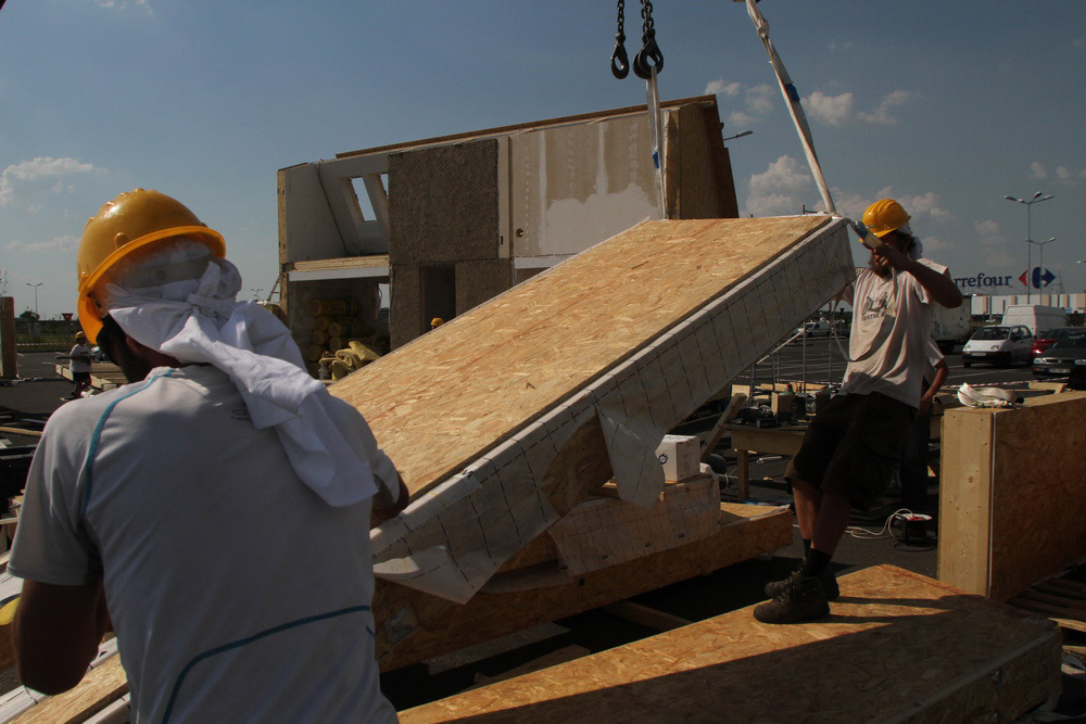 Construction workers building PRISPA house.